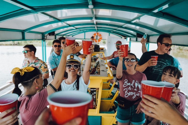 a group of people standing next to a cup of coffee