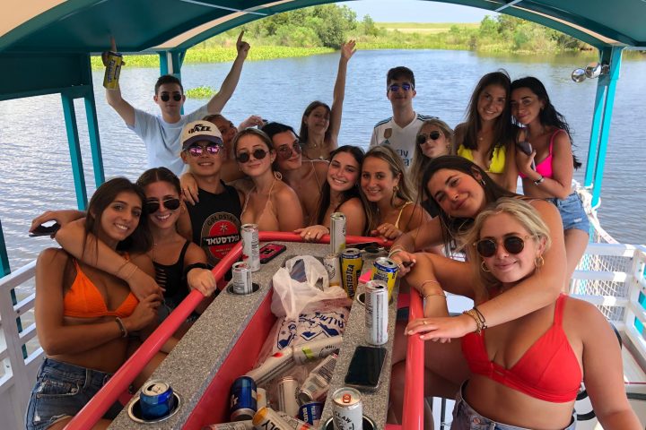 a group of people on a boat posing for the camera