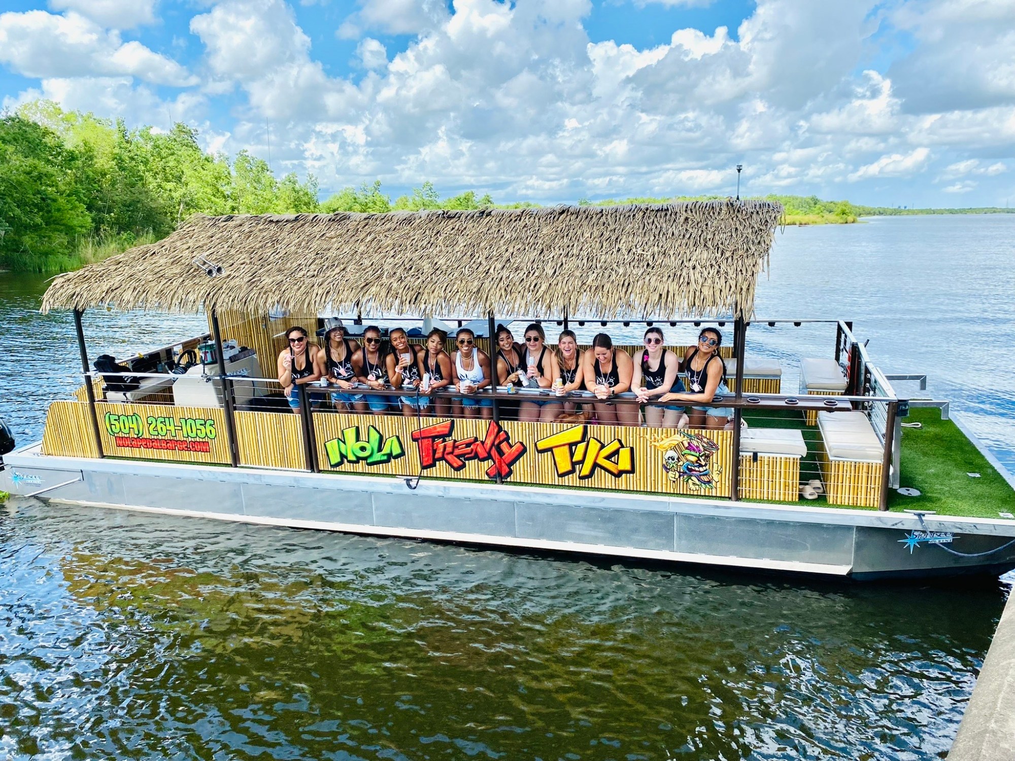 freakytiki a group of people in a boat on a body of water