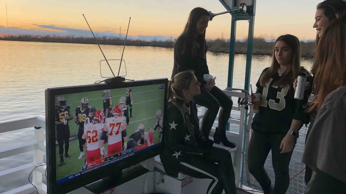 IMG_8202 a group of people standing in front of a boat