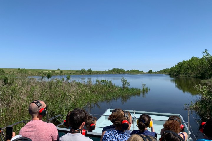 a group of people standing next to a body of water