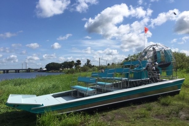 a boat sitting on top of a grass covered field