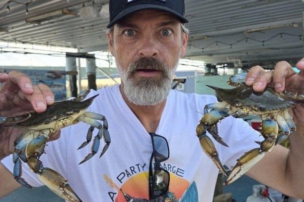 a man holding a crab